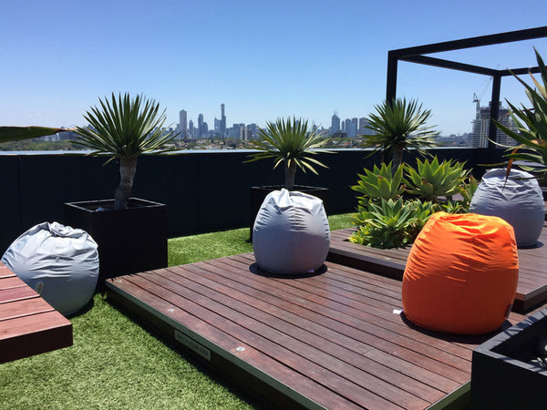 Outdoor water resistant bean bags: Silver grey and orange on rooftop
